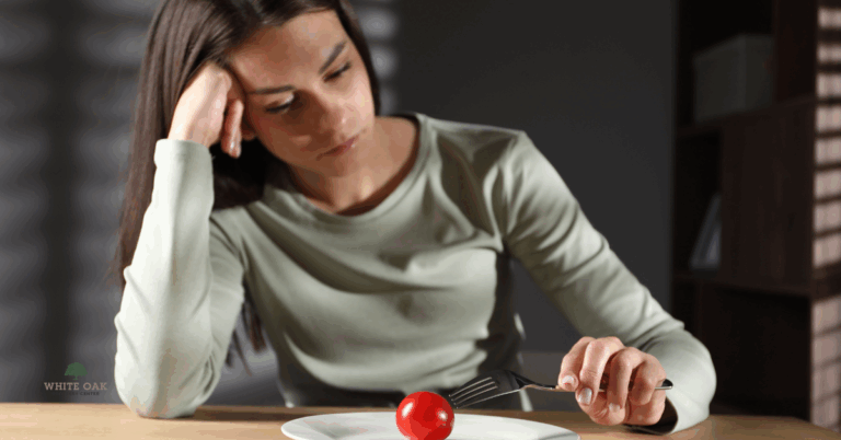 Young woman struggling with food avoidance, symbolising Avoidant Restrictive Food Intake Disorder (ARFID) treatment support at White Oak Recovery Center