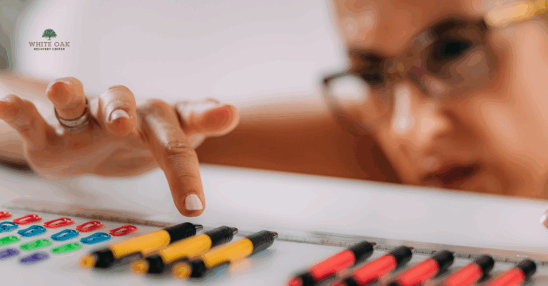 Close-up of a person meticulously arranging pens and paperclips, symbolising obsessive-compulsive disorder and co-occurring addiction treatment at White Oak Recovery Center