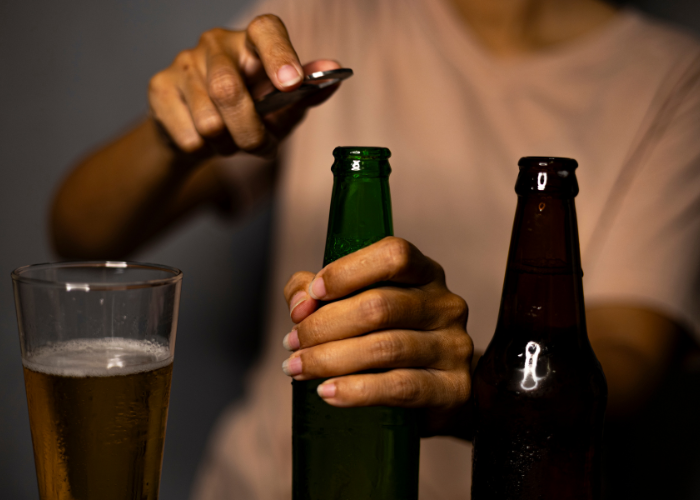 using a bottle opener to open a beer
